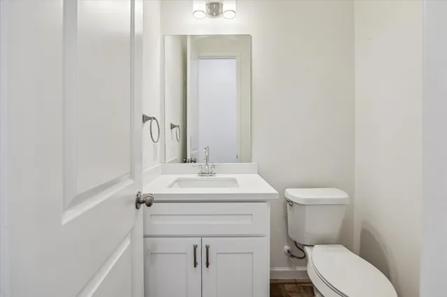 a bathroom with a sink a toilet and mirror
