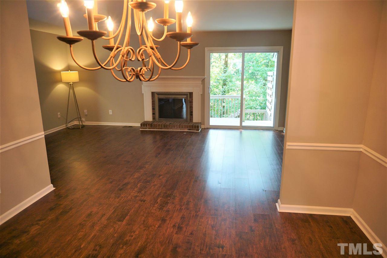 5710 Pool Side Drive Raleigh, NC 27612 - Photo 4 of 6 a view of an empty room with wooden floor and a window