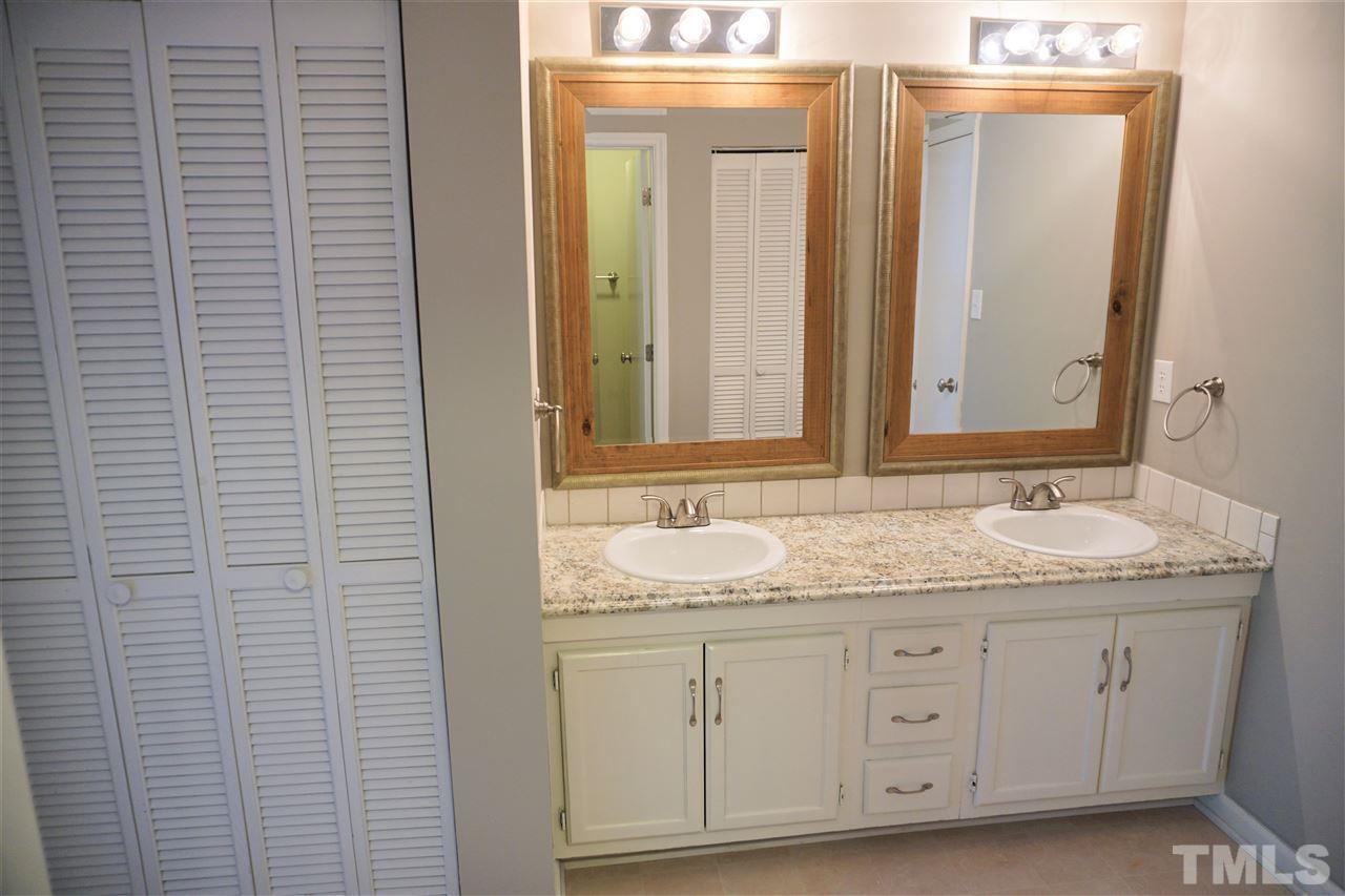 5710 Pool Side Drive Raleigh, NC 27612 - Photo 6 of 6 a bathroom with a granite countertop sink and a mirror