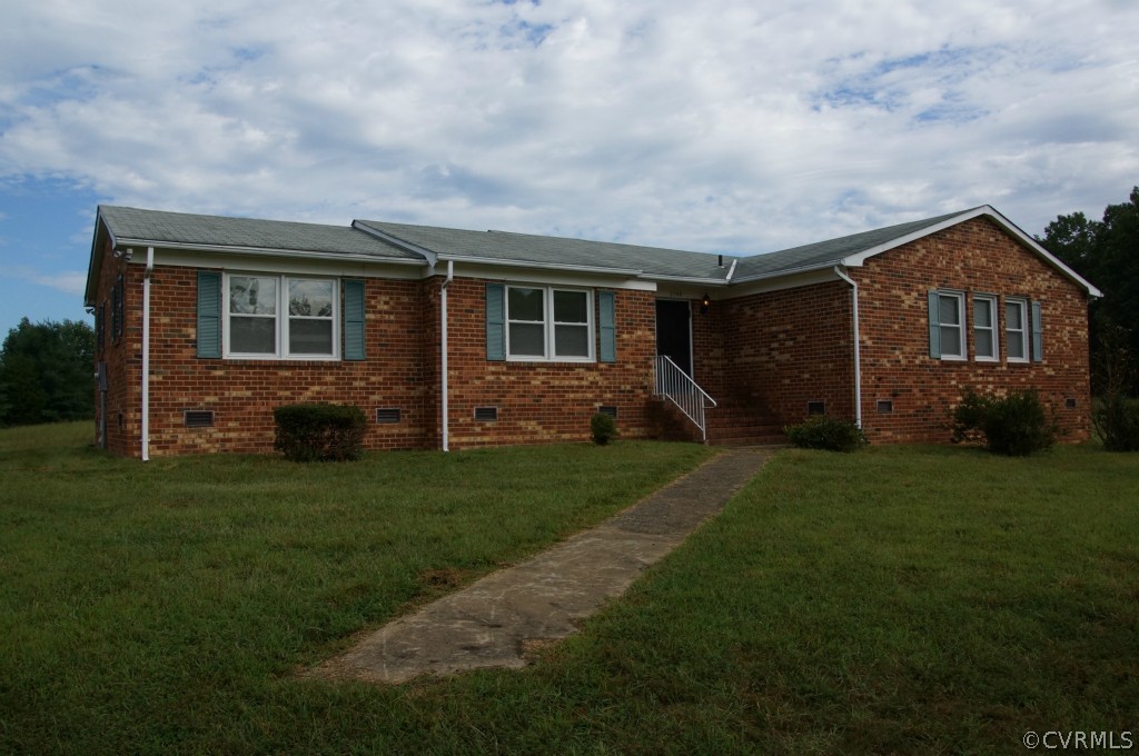 a front view of house with yard and green space