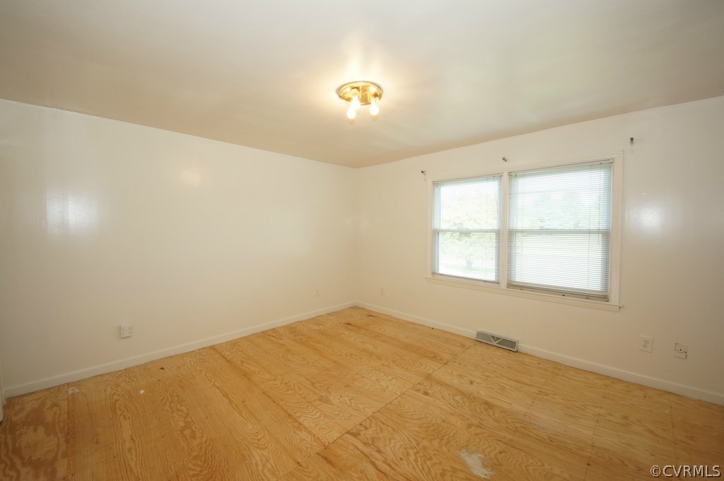 2244 Pony Farm Road Maidens, VA 23102 - Photo 9 of 13 wooden floor in an empty room with a window
