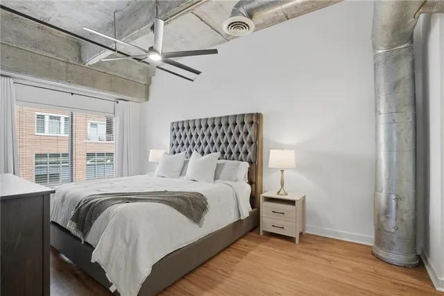 a bedroom with a bed and wooden floor