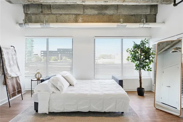 a bedroom with a bed and a potted plant