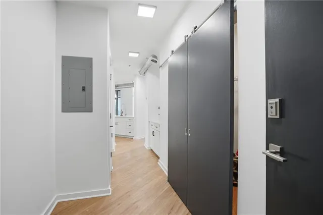 a view of a hallway with wooden floor