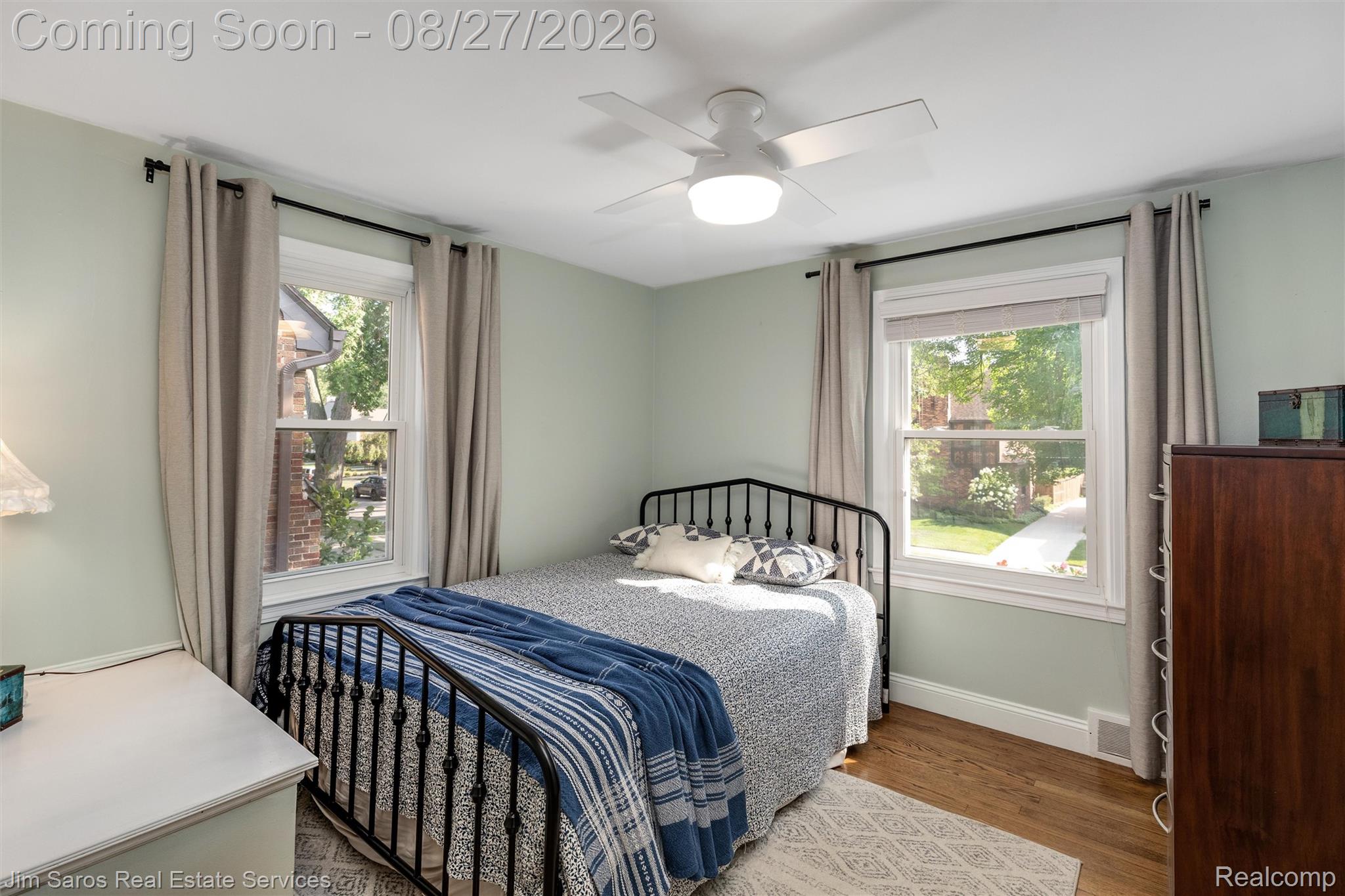 276 Moran Road Grosse Pointe, MI 48236 - Photo 15 of 23 Hardwood flooring, two windows, ceiling fan with integrated lighting, and light-toned wall paint