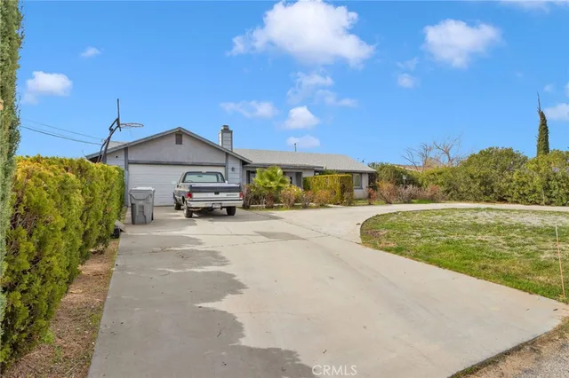 a car parked in front of a house with a yard
