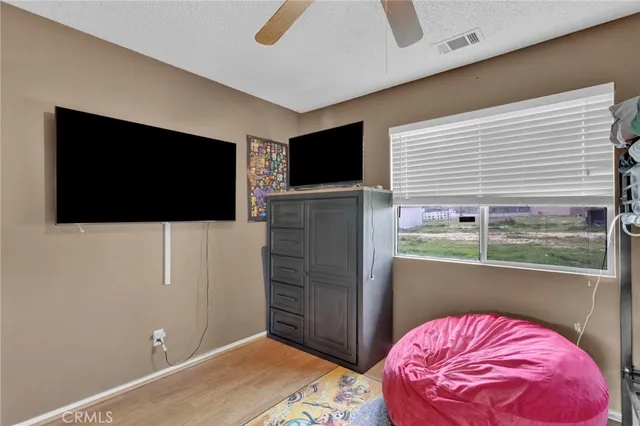 a living room with a flat screen tv and a floor to ceiling window