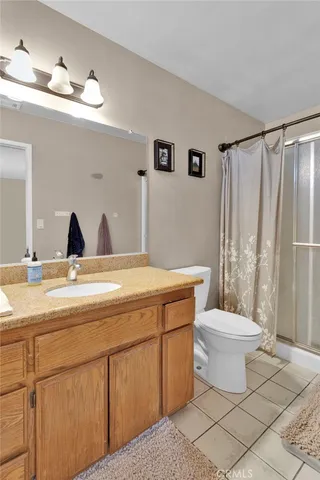 a bathroom with a toilet a sink and a mirror