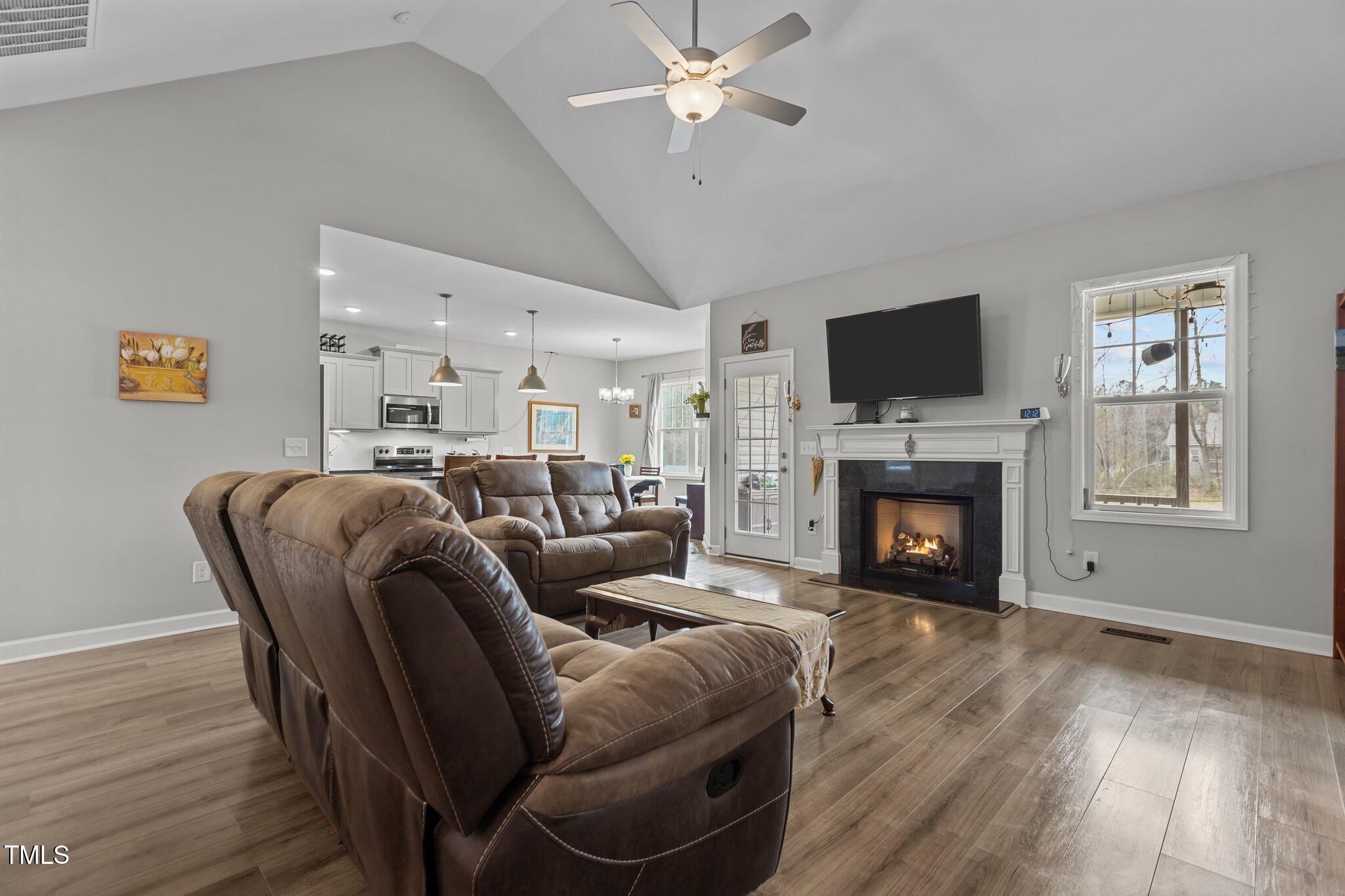 240 Northview Drive Middlesex, NC 27557 - Photo 15 of 58 a living room with furniture a flat screen tv and a fireplace