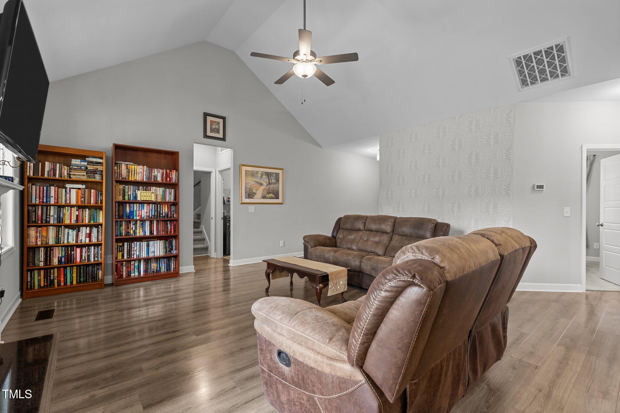 240 Northview Drive Middlesex, NC 27557 - Photo 17 of 58 a living room with furniture a ceiling fan and a bookshelf