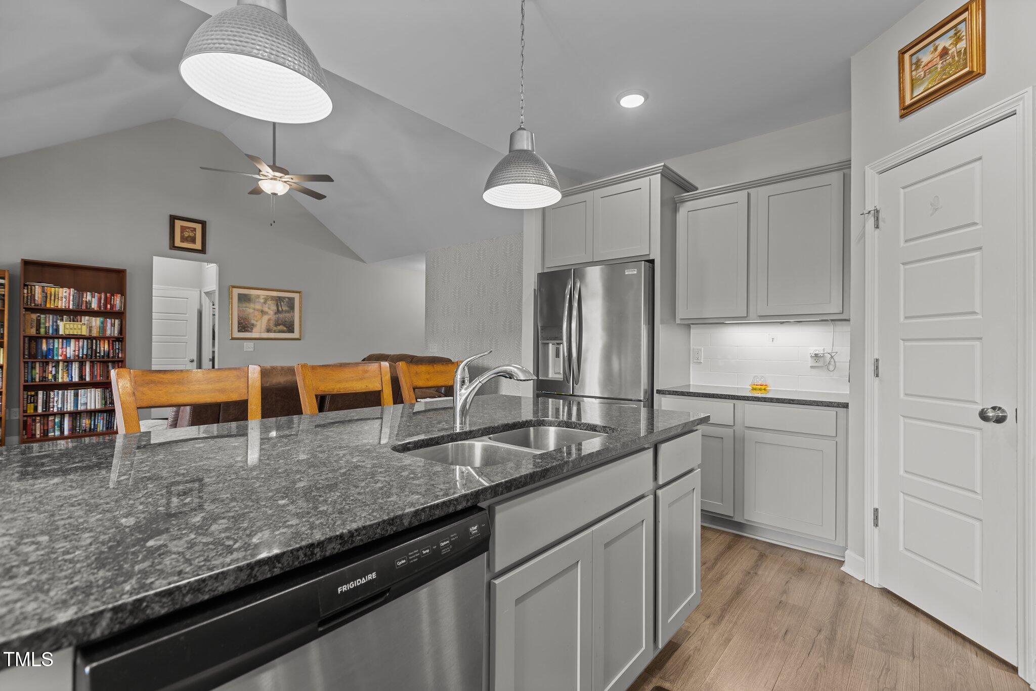 240 Northview Drive Middlesex, NC 27557 - Photo 20 of 58 a kitchen with stainless steel appliances granite countertop a sink refrigerator and cabinets
