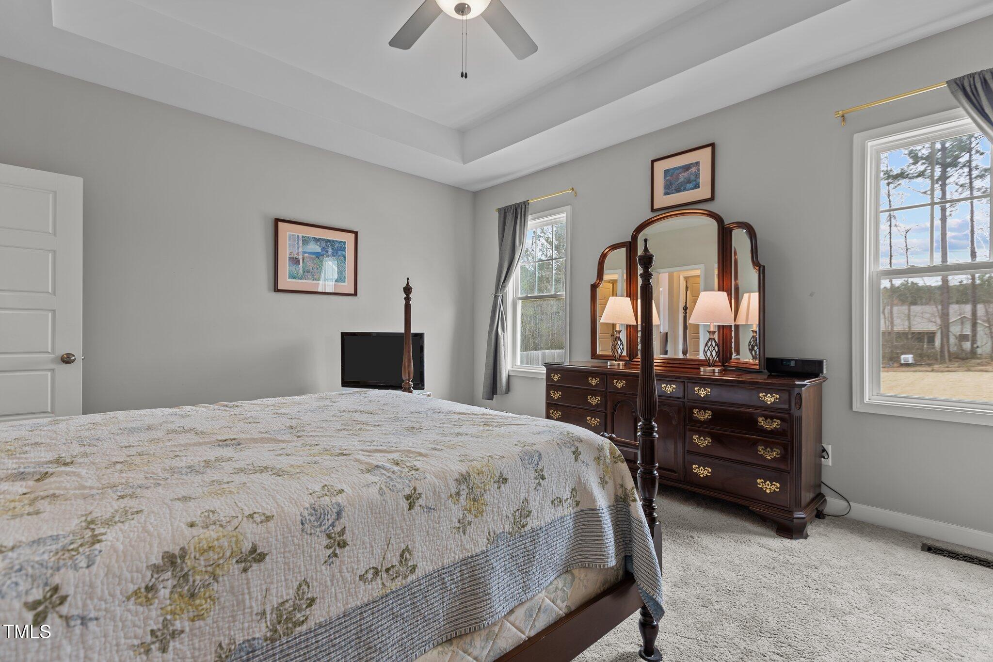240 Northview Drive Middlesex, NC 27557 - Photo 26 of 58 a bedroom with a bed and a dresser with mirror