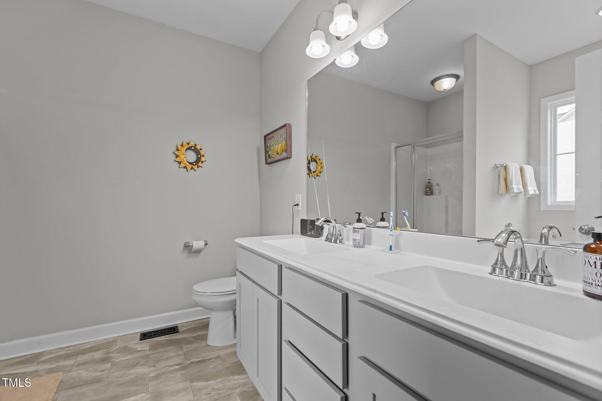 240 Northview Drive Middlesex, NC 27557 - Photo 29 of 58 a bathroom with a sink a toilet and a mirror