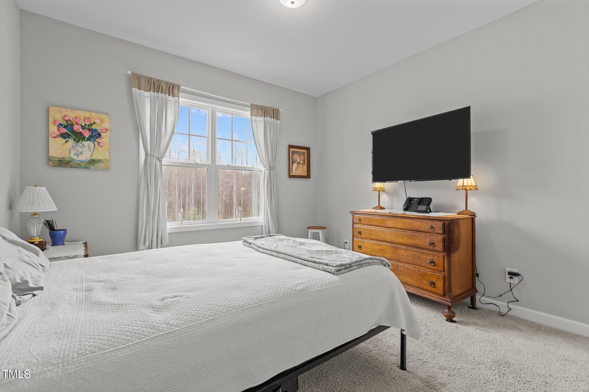 240 Northview Drive Middlesex, NC 27557 - Photo 35 of 58 a bedroom with a bed and a flat screen tv