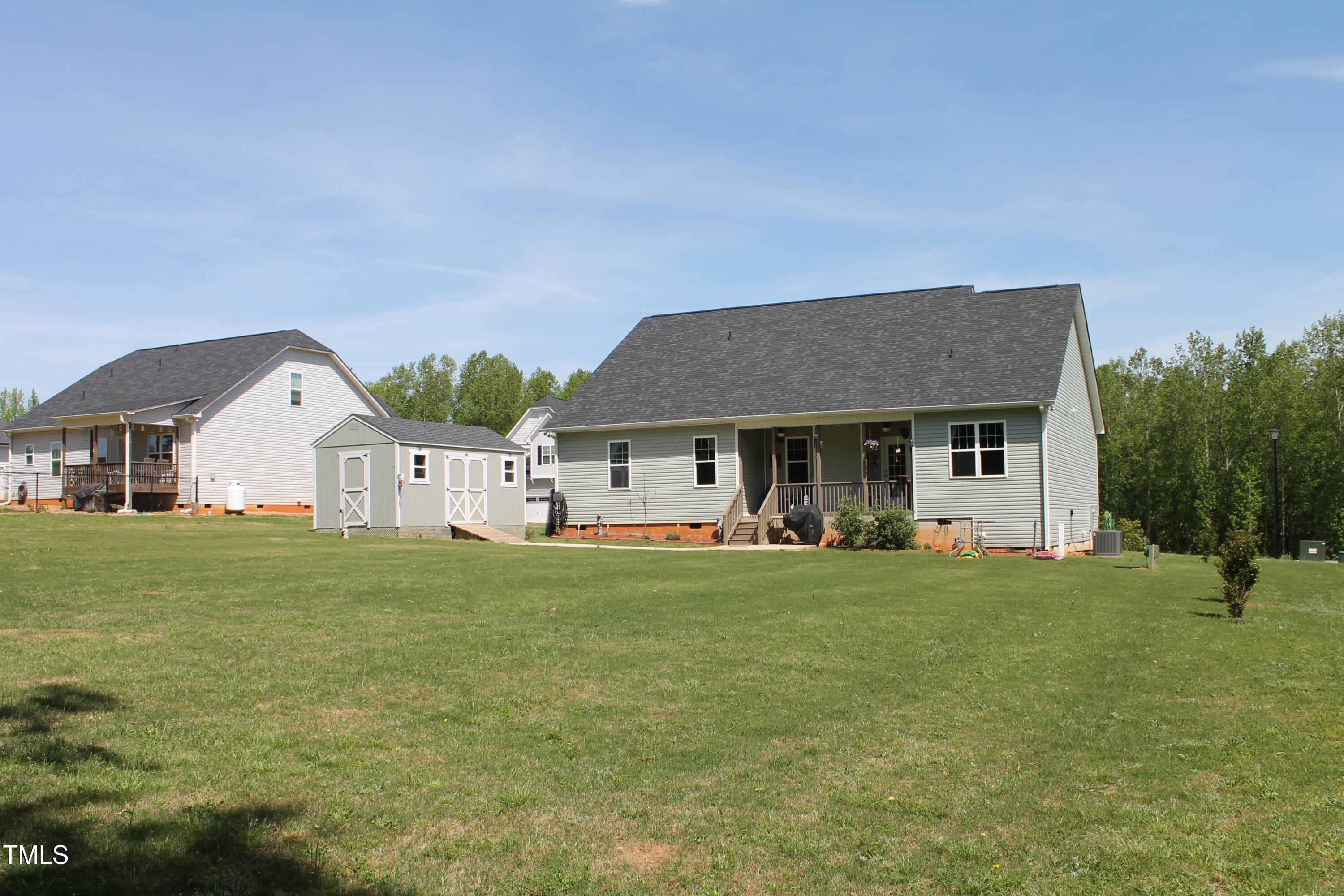 240 Northview Drive Middlesex, NC 27557 - Photo 43 of 58 a front view of a house with a garden and trees