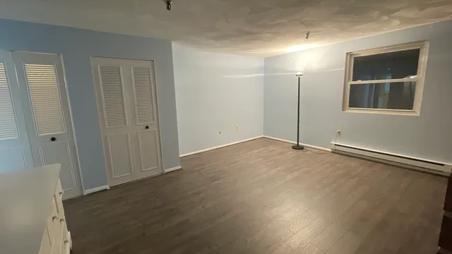 a view of a room with wooden floor and stairs
