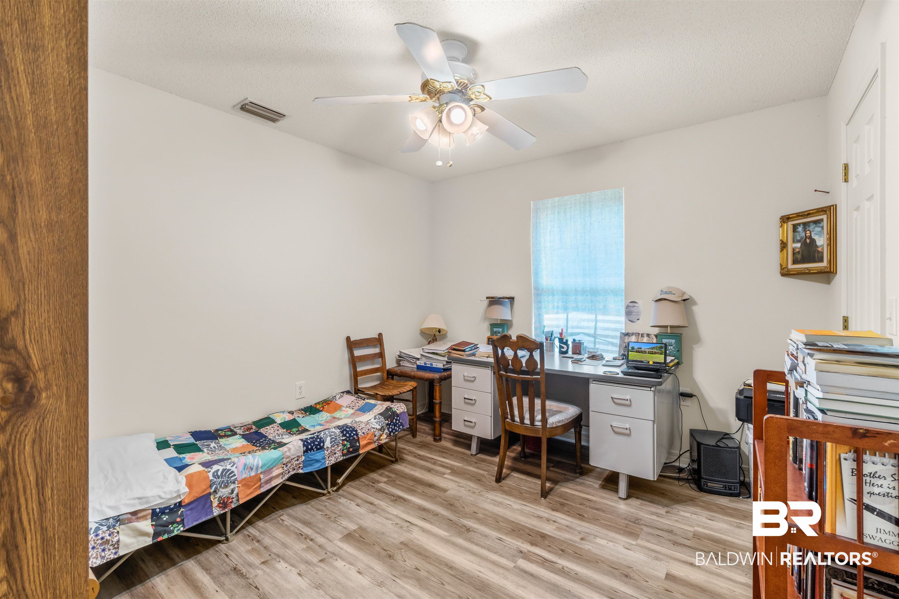 35893 Pine Road South Stapleton, AL 36578 - Photo 22 of 31 Room featuring wood-finish flooring, a ceiling fan with integrated lighting, and a single window with blinds
