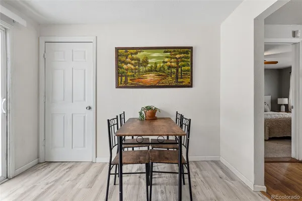 a view of a dining room with furniture and wooden floor