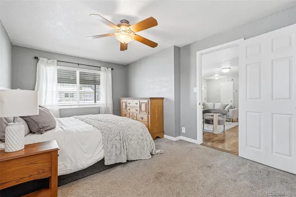 a bedroom with a bed and a large window