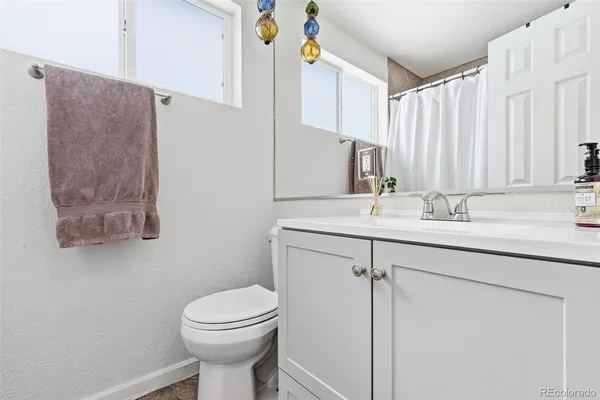 a bathroom with a sink toilet and a mirror