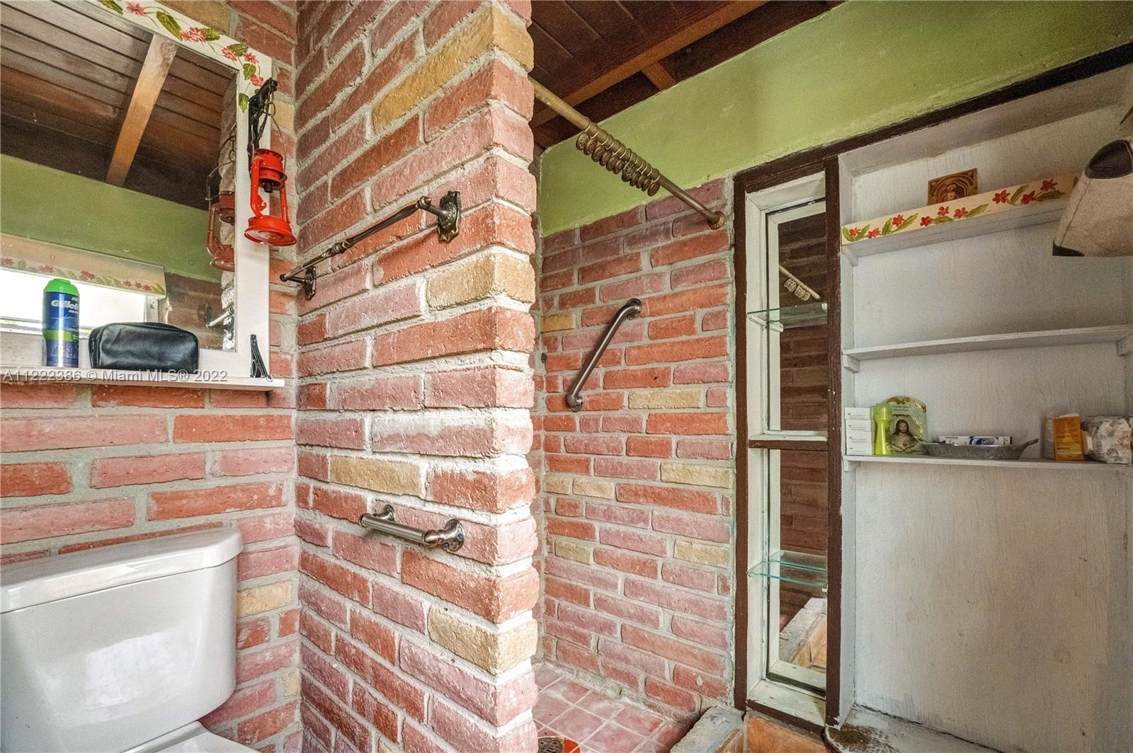 830 East 18th Street Hialeah, FL 33013 - Photo 12 of 37 a bathroom with a window and a shower