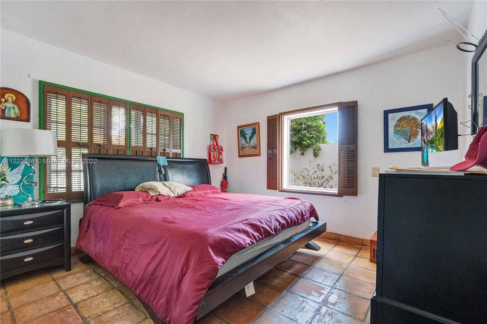830 East 18th Street Hialeah, FL 33013 - Photo 16 of 37 a bedroom with a bed dresser and window