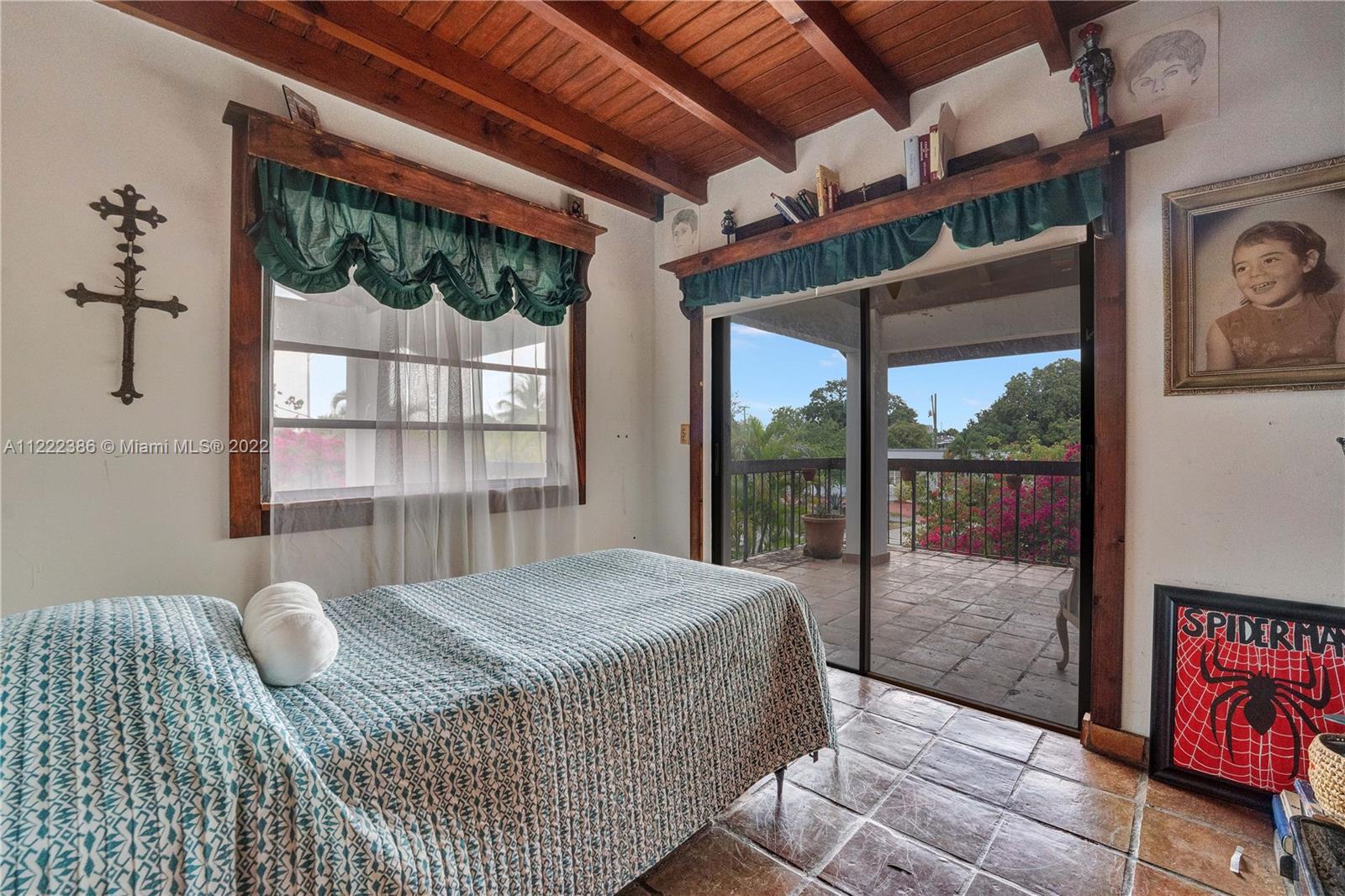 830 East 18th Street Hialeah, FL 33013 - Photo 25 of 37 a bedroom with a bed and glass window