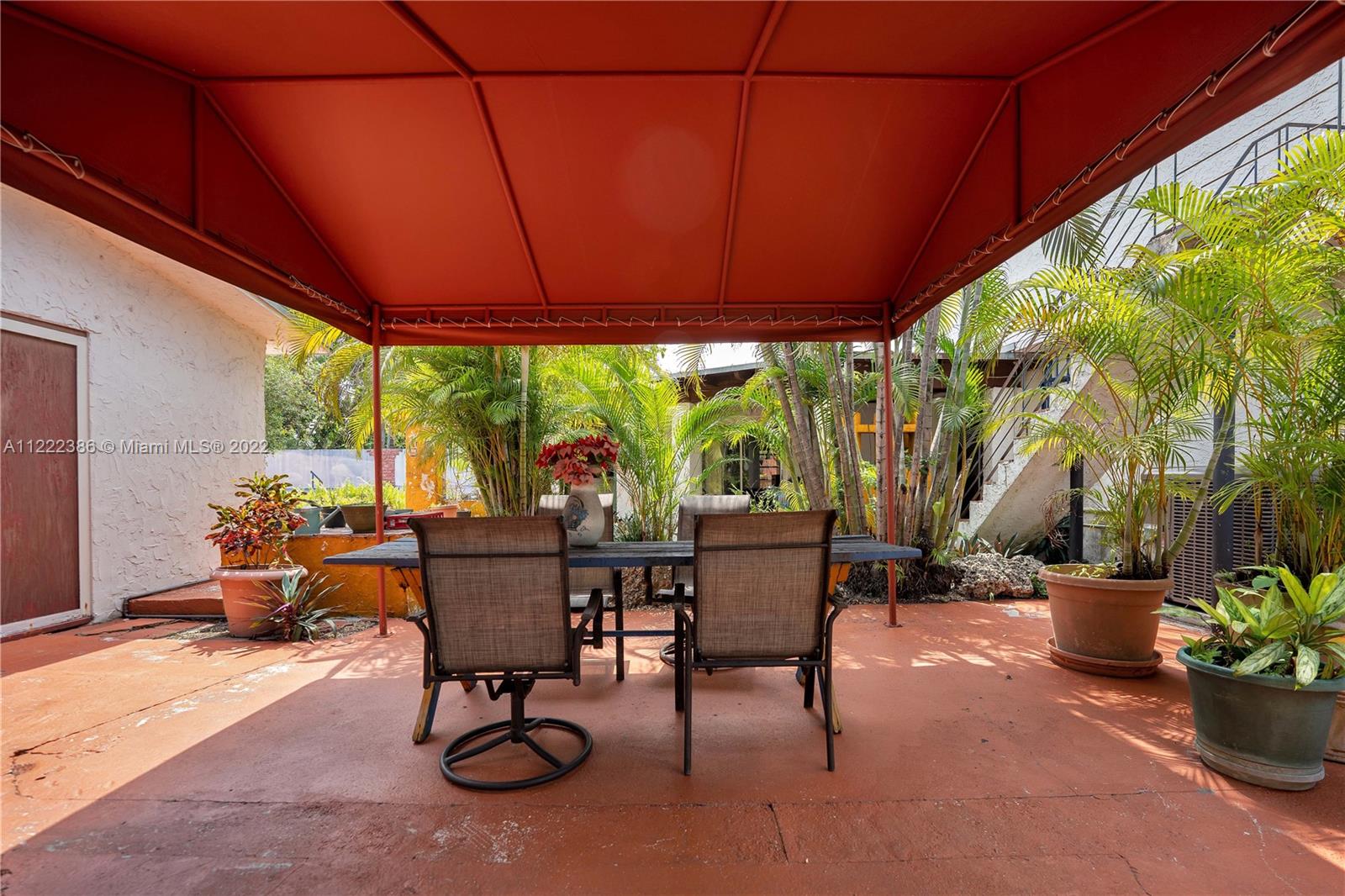830 East 18th Street Hialeah, FL 33013 - Photo 33 of 37 a living room with patio furniture and potted plants