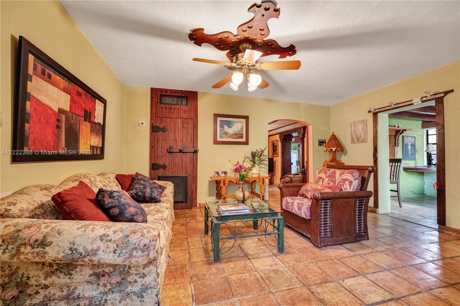830 East 18th Street Hialeah, FL 33013 - Photo 7 of 37 a living room with fireplace furniture and a chandelier