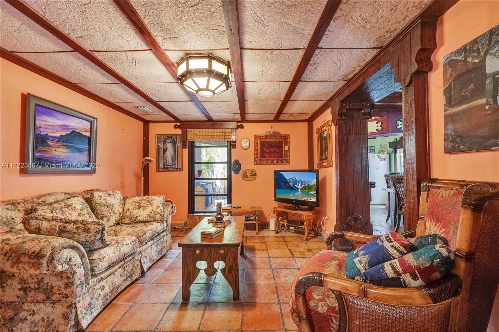 830 East 18th Street Hialeah, FL 33013 - Photo 8 of 37 a living room with furniture a couch and a chandelier