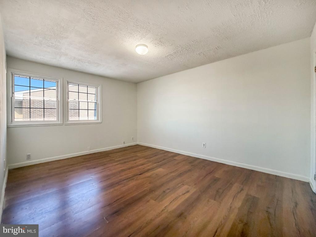 3850 Woodhaven Road, Unit 901 Philadelphia, PA 19154 - Photo 15 of 24 an empty room with wooden floor and windows
