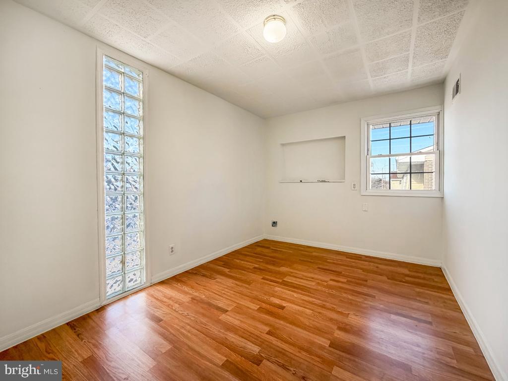 3850 Woodhaven Road, Unit 901 Philadelphia, PA 19154 - Photo 18 of 24 an empty room with wooden floor and windows