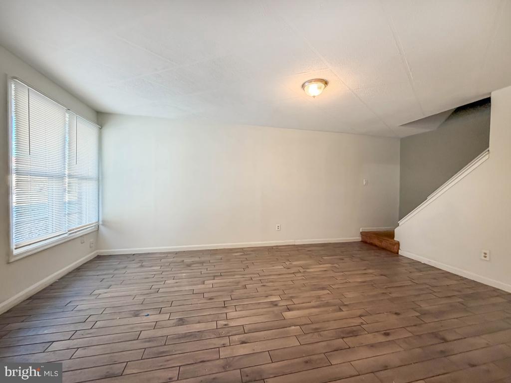 3850 Woodhaven Road, Unit 901 Philadelphia, PA 19154 - Photo 8 of 24 a view of an empty room with wooden floor and a window