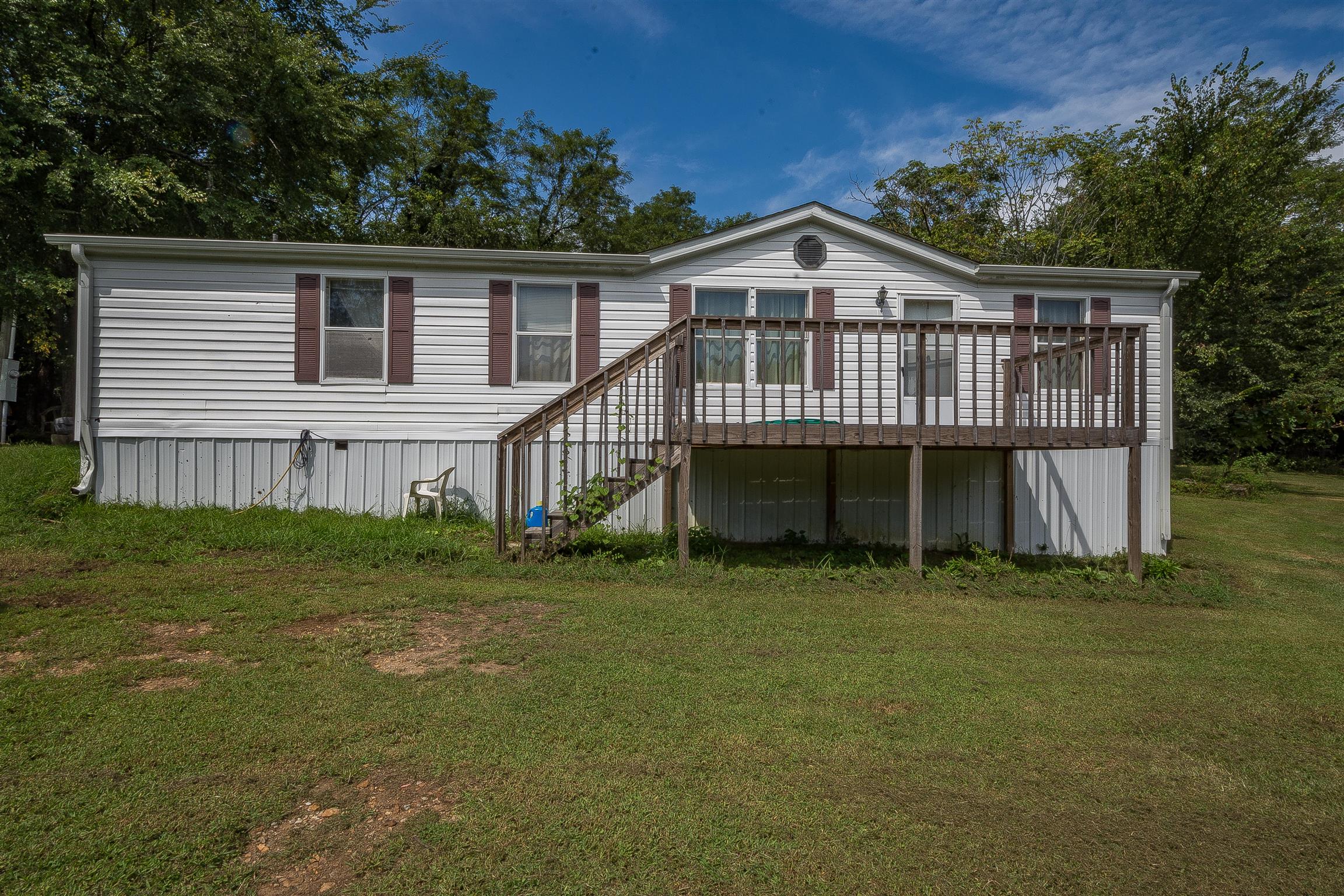 667 Petty Hollow Road Prospect, TN 38477 - Photo 6 of 28 a view of a house with a wooden deck and a yard