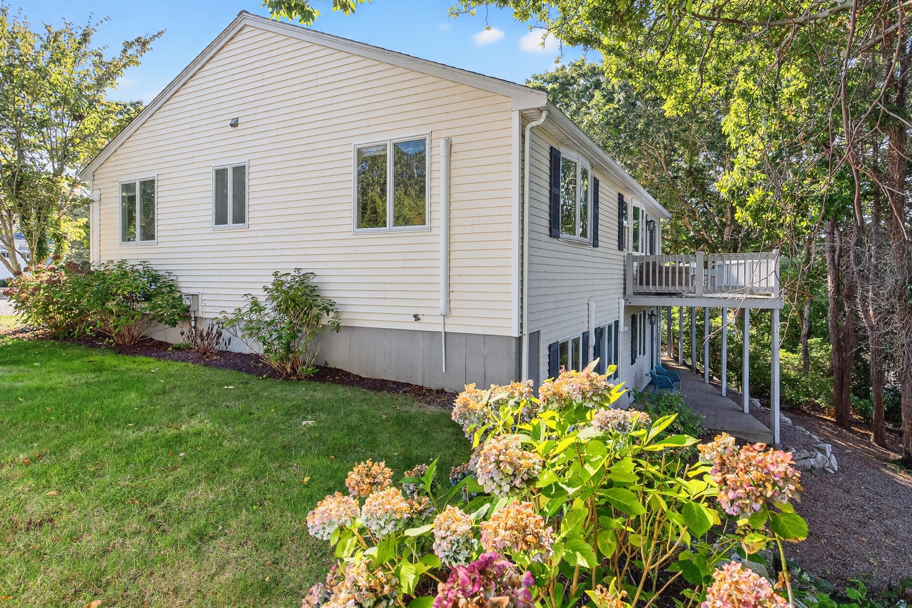 24 Jae Road Falmouth, MA 02556 - Photo 21 of 27 a front view of a house with a yard