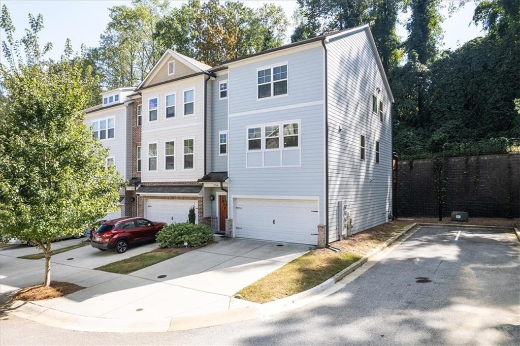 2765 White Oak Lane Decatur, GA 30032 - Photo 1 of 1 a view of a white house with a small yard plants and large tree