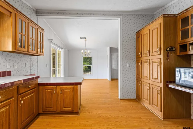 a view of a kitchen cabinets and wooden floor