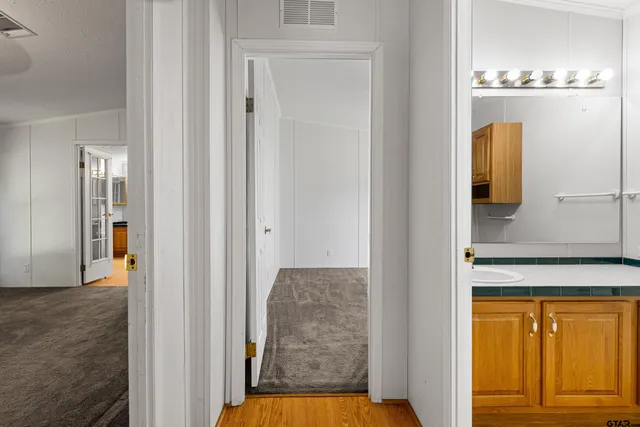a view of walk in closet and bathroom