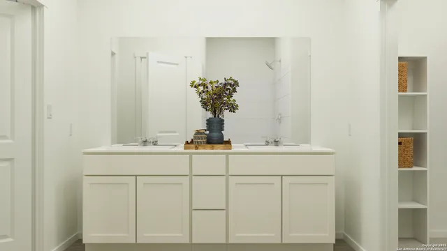 a bathroom with a sink vanity and mirror