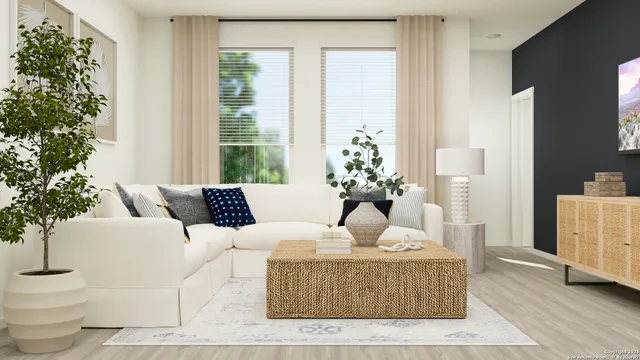 a living room with furniture and a potted plant