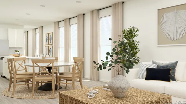 a living room with furniture and potted plants