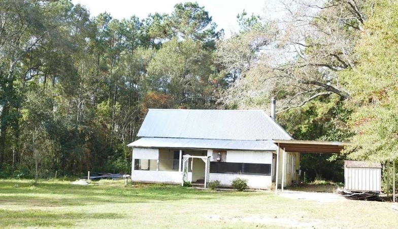 1547 Lee Miller Road Silsbee, TX 77656 - Photo 2 of 3 a front view of a house with a yard
