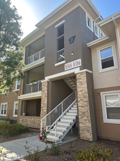 a front view of a house with stairs