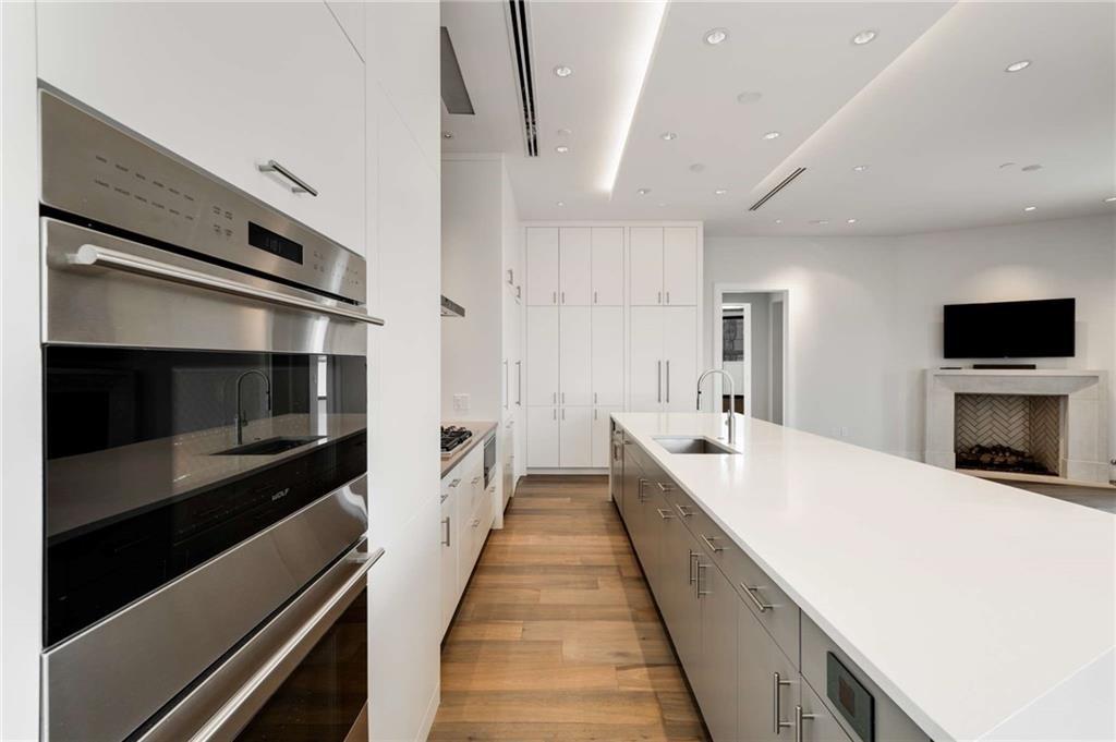 3376 Peachtree Road Northeast, Unit 33B Atlanta, GA 30326 - Photo 13 of 45 a large kitchen with stainless steel appliances a large counter top