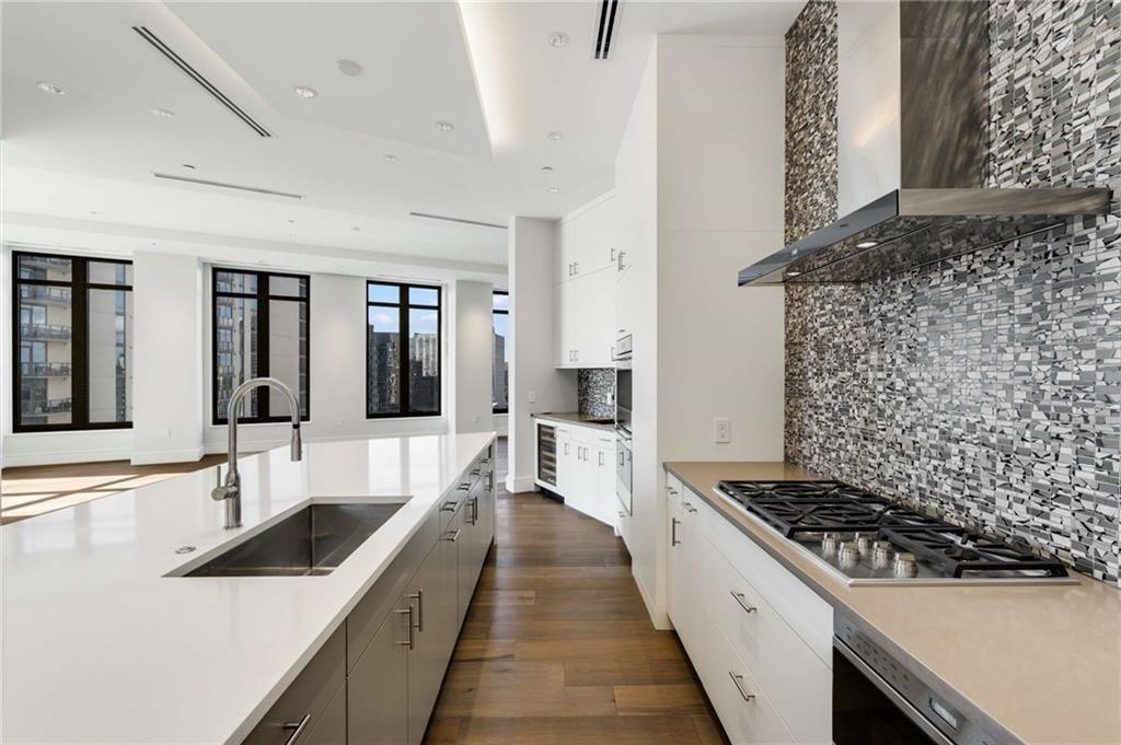 3376 Peachtree Road Northeast, Unit 33B Atlanta, GA 30326 - Photo 14 of 45 a large white kitchen with a large window