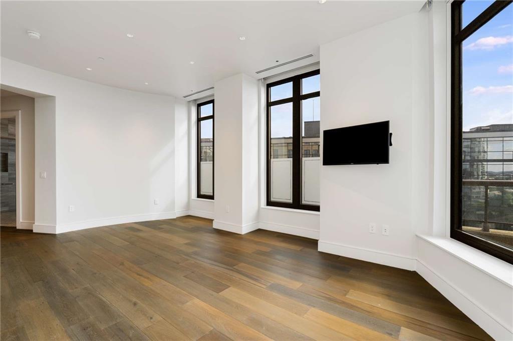 3376 Peachtree Road Northeast, Unit 33B Atlanta, GA 30326 - Photo 18 of 45 a view of an empty room with wooden floor and a window