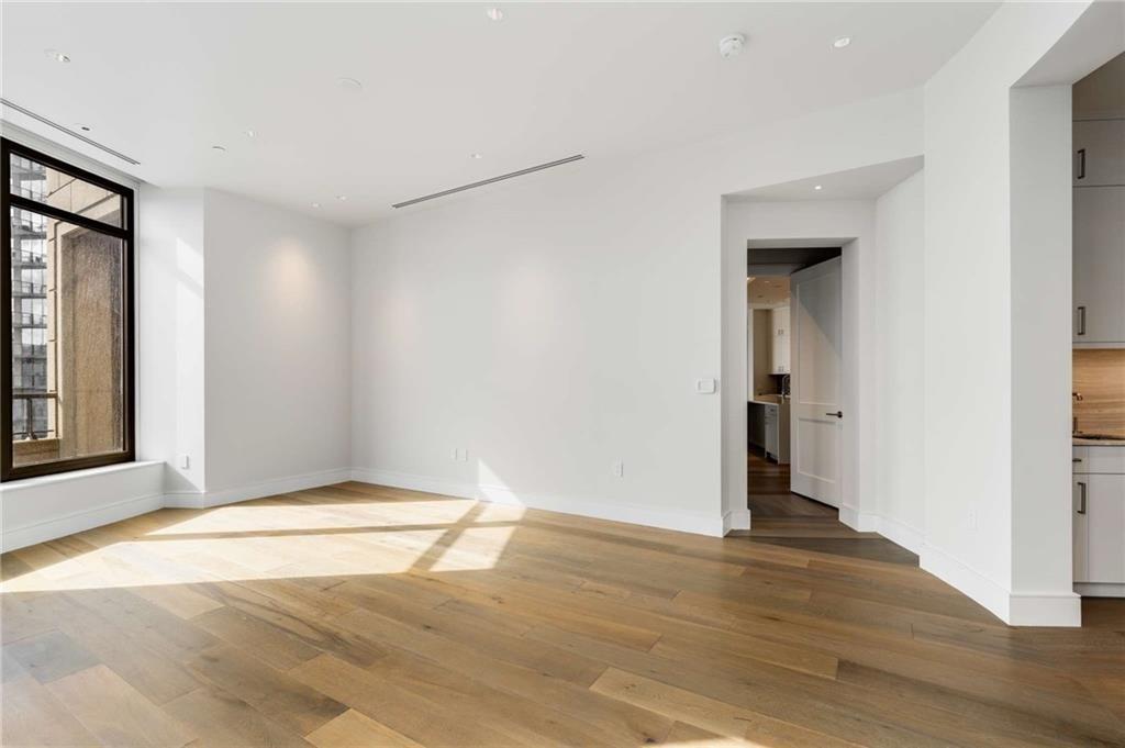 3376 Peachtree Road Northeast, Unit 33B Atlanta, GA 30326 - Photo 19 of 45 a view of an empty room with wooden floor and a window