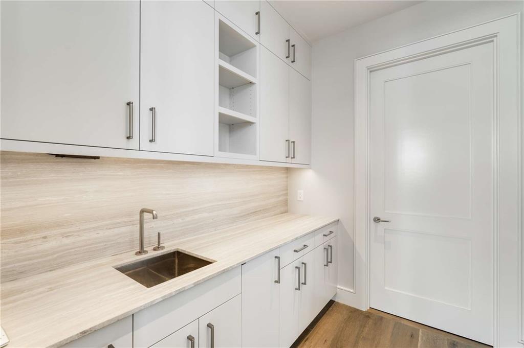 3376 Peachtree Road Northeast, Unit 33B Atlanta, GA 30326 - Photo 20 of 45 a kitchen with white cabinets and sink