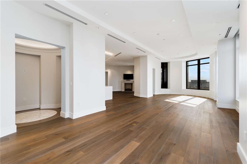 3376 Peachtree Road Northeast, Unit 33B Atlanta, GA 30326 - Photo 2 of 45 a view of a big room with wooden floor and windows