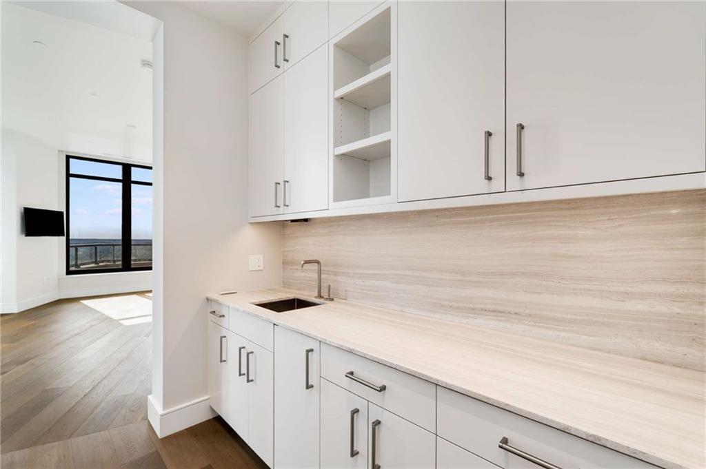 3376 Peachtree Road Northeast, Unit 33B Atlanta, GA 30326 - Photo 21 of 45 a kitchen with stainless steel appliances cabinets and a window